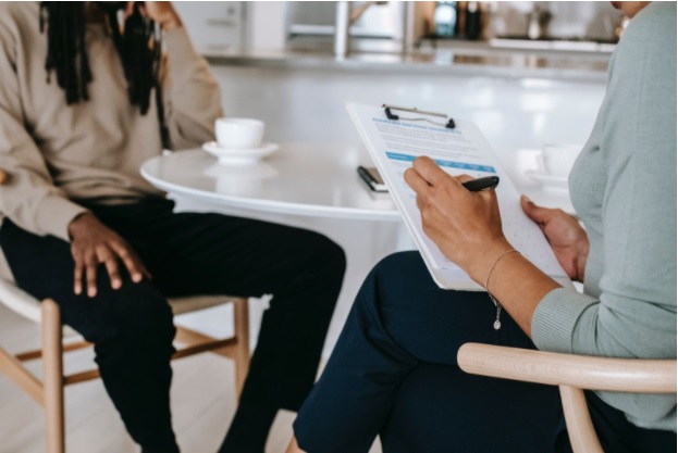 A landlord signing paperwork with a tenant