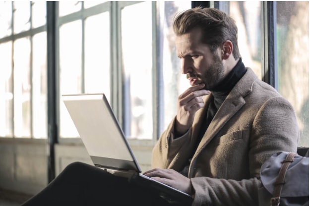 A man intently looking at his laptop